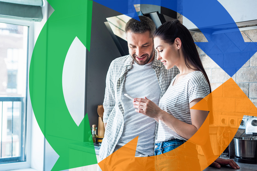 Husband and wife use smartphone in kitchen with Conexon icon around for thumbnail.
