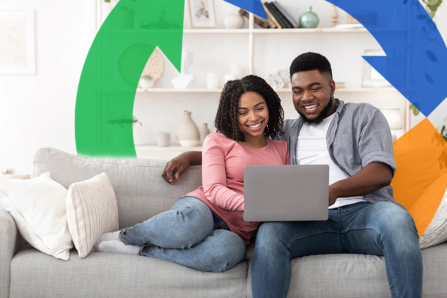 Husband and wife sit on couch using a laptop with Conexon icon around them for thumbnail